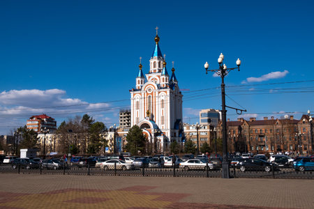 View of one of the streets of Khabarovsk in the daytime against a blue bright sky and white clouds. The combination of ancient architecture with modern buildings.のeditorial素材