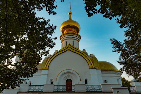 Beautiful view during sunset at the temple of St. Seraphim of Sarov in the city of Khabarovsk. A beautiful green lawn in the foreground. Religious architecture, buildings and traditions. Russia.の写真素材