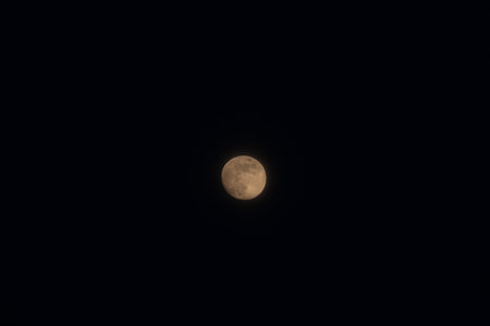 Full moon isolated on a black skyの写真素材