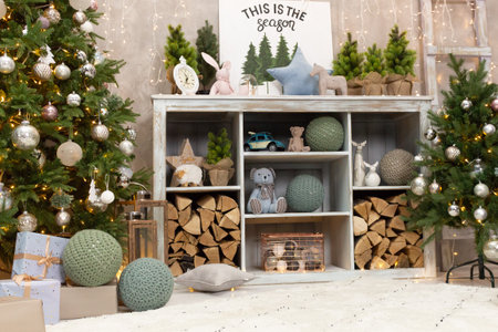 Gift boxes wrapped around the Christmas tree on the background. Cozy house is decorated to celebrate the New year.の写真素材