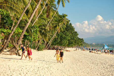 Boracay, Philippines - Jan 29, 2020: White beach of Boracay island. Tourists walk along the beach...