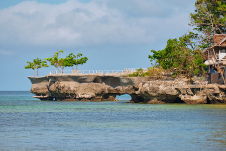 famous landmark of Boracay island. A small rock in the sea. Tourists are photographed on the background of the white beach of the islandの写真素材