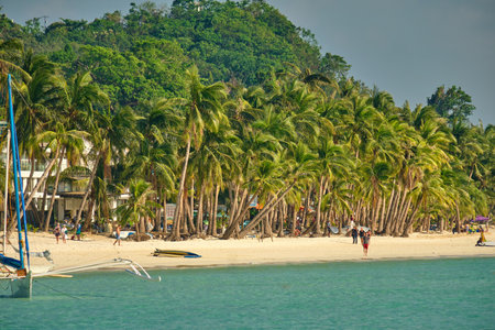 White beach of Boracay island. Tourists walk along the beach and swim in the sea. A few days before the outbreak of the coronavirusの写真素材