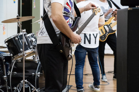 Drummer playing his kit. Rock band performs in the gym