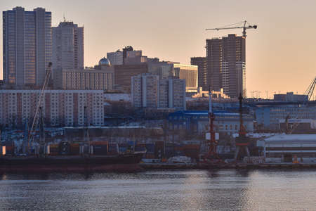 Vladivostok, Russia - Dec 22, 2020: Evening view of Cape Churkin and the Golden Horn Bay, where ships stand in the seaportのeditorial素材