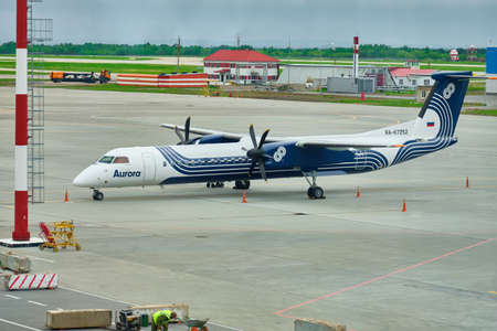 KHABAROVSK, RUSSIA - May 26, 2021: Bombardier DHC-8-400 RA-67252 AURORA airline standing at the Khabarovsk Novy airport.のeditorial素材