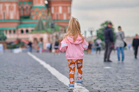 Moscow, Russia - May 27, 2021: A little girl with a childs camera walks along Red Square.のeditorial素材