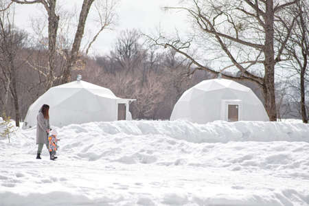 Mom and little daughter are walking through winter glamping.の写真素材