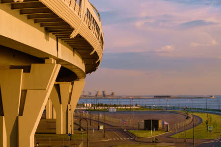 Saint-Petersburg, Russia - Jun 09, 2021: The bridge over the Petrovsky Fairway and the Gulf of Finland at sunset.のeditorial素材