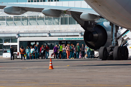 KHABAROVSK, RUSSIA - SEP 29, 2018: People at the airport are standing in line to Board the plane.のeditorial素材