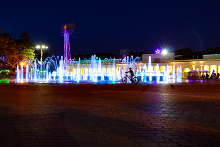 Bright colorful fountains at night on the embankment of the Amur river in the city of Khabarovsk. bright color. Illumination of lanterns.の写真素材