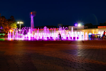 Bright colorful fountains at night on the embankment of the Amur river in the city of Khabarovsk. bright color. Illumination of lanterns.の写真素材