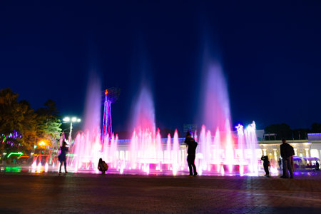 Bright colorful fountains at night on the embankment of the Amur river in the city of Khabarovsk. bright color. Illumination of lanterns.の写真素材