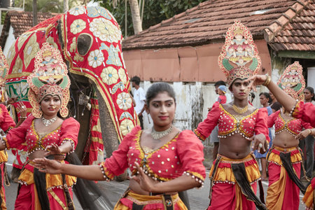 Hikkaduwa, Sri Lanka - Dec 28, 2025: A procession of Sri Lankan people in national costumes during...
