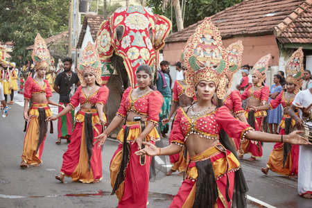 Hikkaduwa, Sri Lanka - Dec 28, 2025: A procession of Sri Lankan people in national costumes during...