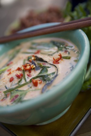 Thai food delicacies presented in traditional settingsの写真素材