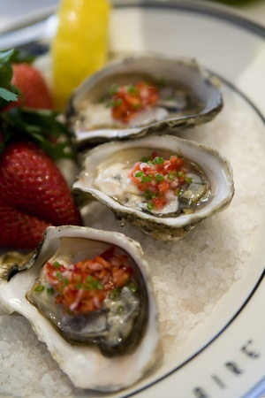 Endless Summer Oysters on ice dressed with strawberry mignonetteの写真素材