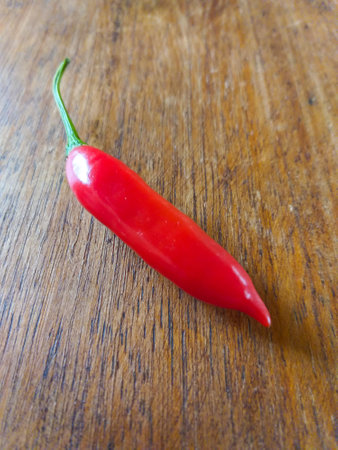 Capsicum baccatum, pepper known as chili pepper or aji pepper, on a wooden tableの写真素材