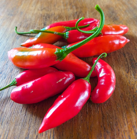 Capsicum baccatum, pepper known as chili pepper or aji pepper, on a wooden tableの写真素材