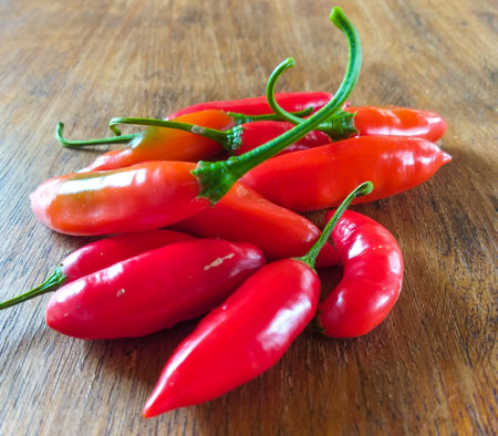 Capsicum baccatum, pepper known as chili pepper or aji pepper, on a wooden tableの写真素材