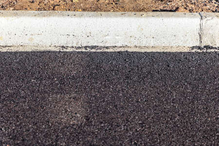 Definitive asphalt paving used on newly applied public roads, with the characteristic color and texture of the petroleum-derived productの写真素材