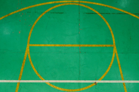 Green basketball court seen from above, with various marks of time, its markings are dirty and discoloredの写真素材