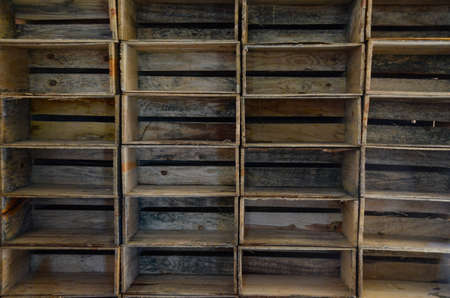 Set of wooden boxes, all stacked and empty, used for the storage and transport of produceの写真素材