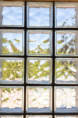 Glass bricks with abstract lighting in various colors and reflection with distorted image