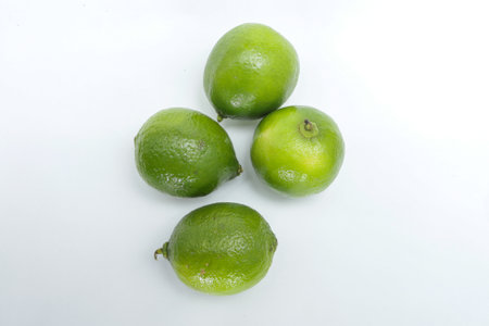 Four whole lemons on a white background, with a top angle, placed next to each other, with two standing and the others lying downの写真素材
