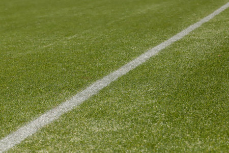 Football field with synthetic grass, with its white diagonal lines.
