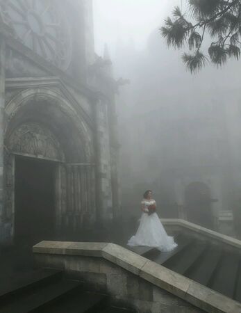 wedding photo in front of church in fogの素材
