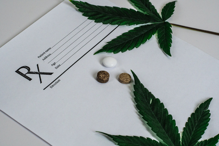Medical Marijuana leaves Close Up Cannabis Buds with Doctors Prescription for Weed and pills on white backgroundの写真素材