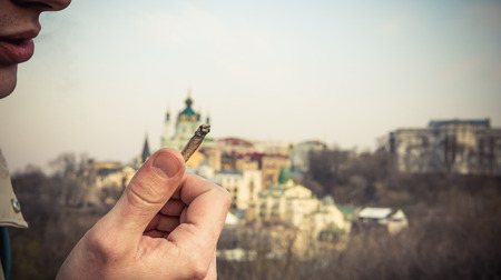 The person hold medical marijuana joint in his hand. Smoking marijuana join