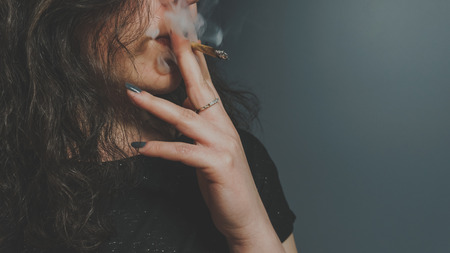 The person smoking medical marijuana joint close-up. Cannabis is medical. Legalization all over the worldの写真素材