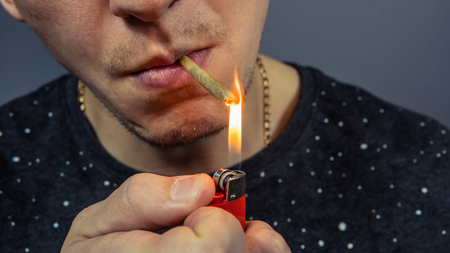 The person smoking medical marijuana joint close-up. Cannabis is medical. Legalization all over the...