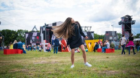 Kyiv, Ukraine - 07.09.2019: Atlas Weekend music festival outdoors, first day. Millennials are relaxin at music festival. People are dancing in the open sky.のeditorial素材