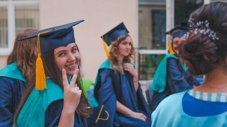 A group of young female graduates. Female graduate is smiling against the background of university...