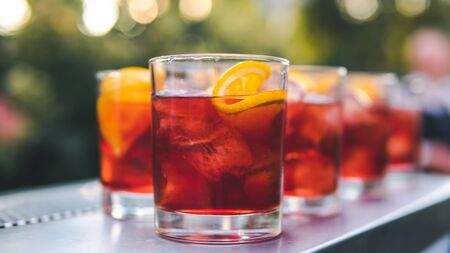 Close-up of colorful exotic cocktail stand on the bar, outdoors. Concept about drink, alcohol and restaurant service, cateringの写真素材