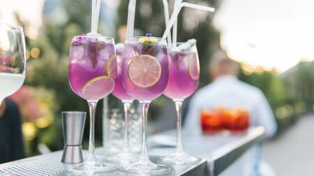 Close-up of colorful exotic cocktail stand on the bar, outdoors. Concept about drink, alcohol and restaurant service, cateringの写真素材