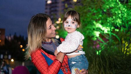 09/05/2019, Kyiv, Ukraine: Actors in suits of Spiderman and Batman working at the Birthday party for little children. Children play with animators, outdoorsのeditorial素材
