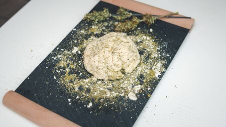 Preparing to cooking hemp cake or bread. Close-up of fresh dough with cannabis flour. Concept of uses marijuana in a food industryの写真素材