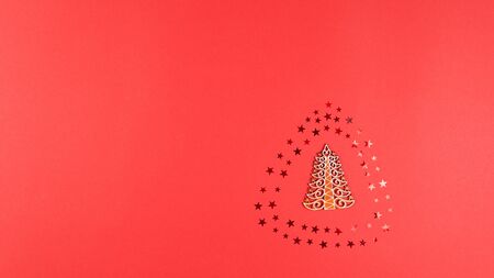 Concept of Christmas and New Year holiday and sale. Flat lay of wooden Christmas tree, confetti...