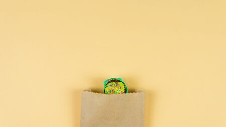 Colorful muffin dancing on yellow background. Concept of bakery products and confectionery. Top...