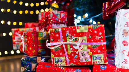 New Year presets in box on a background of colorful beautiful bokeh, close-up. Concept of Christmas...
