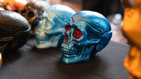 A collection of multi-colored ceramics skulls, close-up. Hand painted skulls for Halloween and Mexican Day of the dead decoration.の写真素材