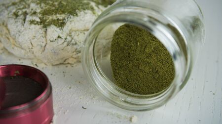 Preparing to cooking hemp cake or bread. Close-up of fresh dough with cannabis flour. Concept of uses marijuana in a food industryの写真素材