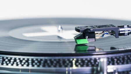 Close-up of modern turntable vinyl record player with music plate. Needle on a vinyl record. Concept...