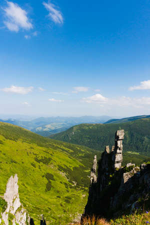 Amazing mountain landscape with blue sky with white clouds, sunny summer day in Carpathians, Ukraine. Natural outdoor travel background.の写真素材
