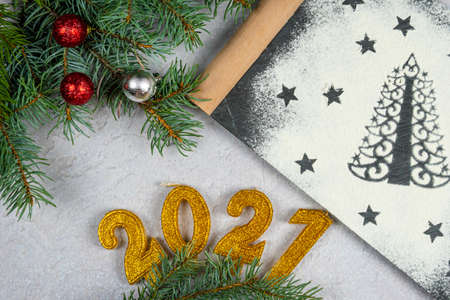 Silhouette of Christmas tree made of flour. Holiday background with the text of the golden number...