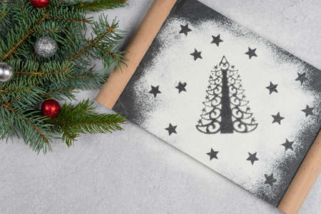 Silhouette of Christmas tree made of flour. Holiday background with copy space, tree branch, top view. Concept of Christmas dinner preparation and New Year eve.の写真素材